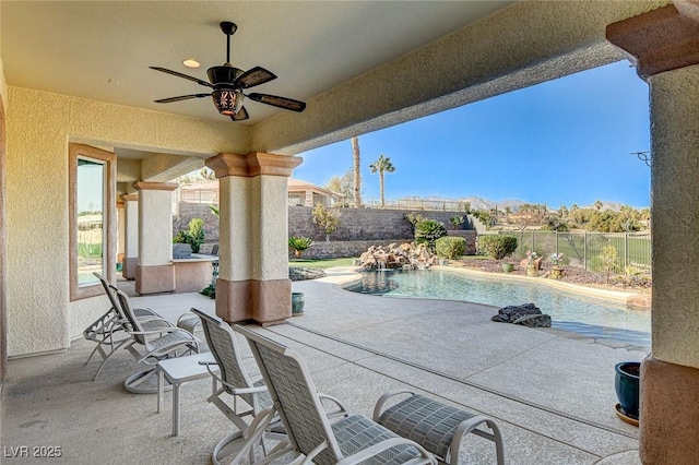 view of patio / terrace with a fenced in pool and ceiling fan