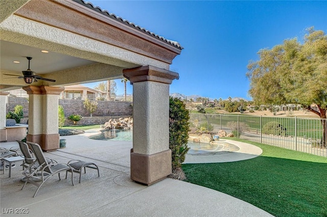 view of patio / terrace with a fenced in pool and ceiling fan