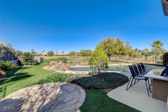 view of yard with a fenced in pool and a patio area