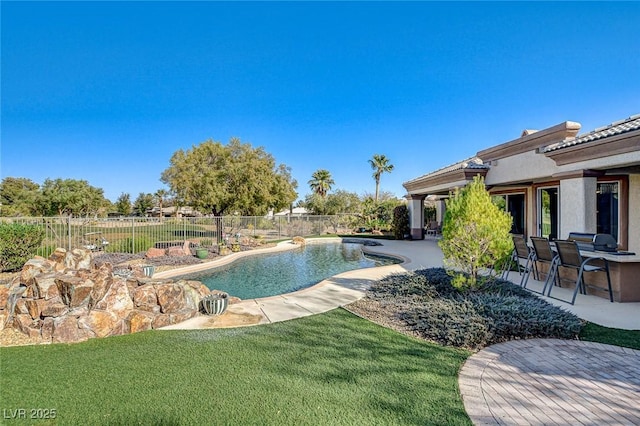 view of swimming pool featuring a patio and a lawn