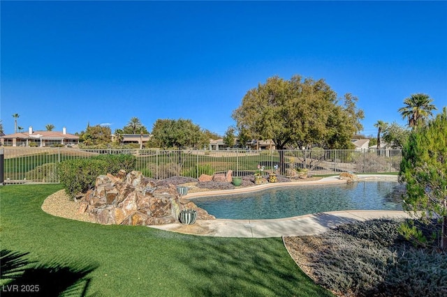 view of swimming pool with a lawn