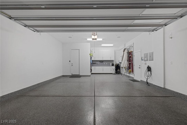 garage with a garage door opener and baseboards