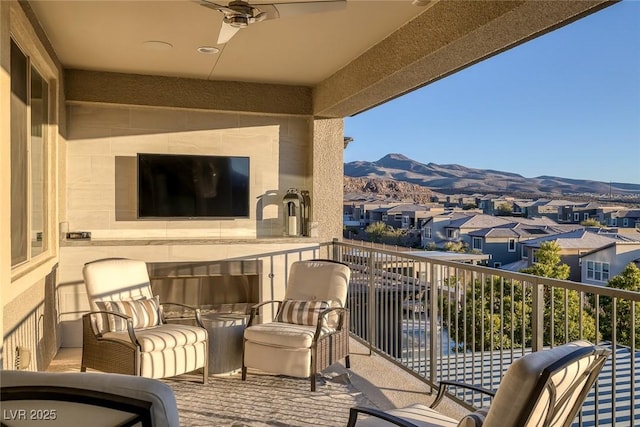 balcony with a residential view and a ceiling fan