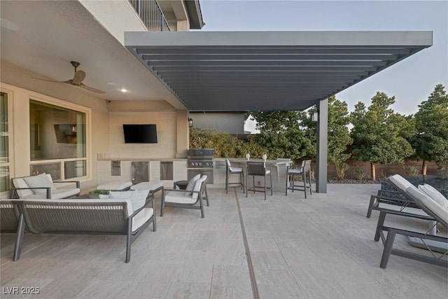 view of patio / terrace with a ceiling fan, a pergola, an outdoor hangout area, and exterior kitchen