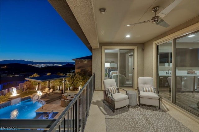 balcony with ceiling fan and a mountain view