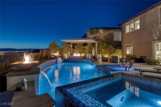 view of pool with a patio and a pool with connected hot tub