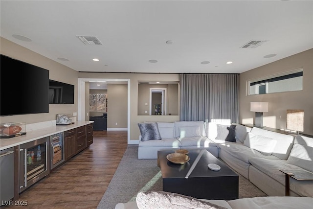 living room featuring dark wood-type flooring, wine cooler, visible vents, and recessed lighting