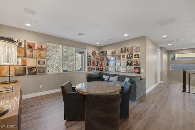 dining room with visible vents, baseboards, and wood finished floors