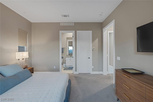 carpeted bedroom featuring connected bathroom, visible vents, and baseboards