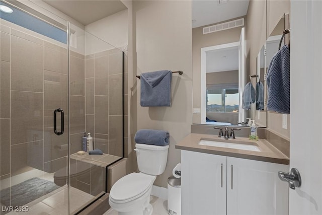 full bathroom with a stall shower, visible vents, vanity, and toilet