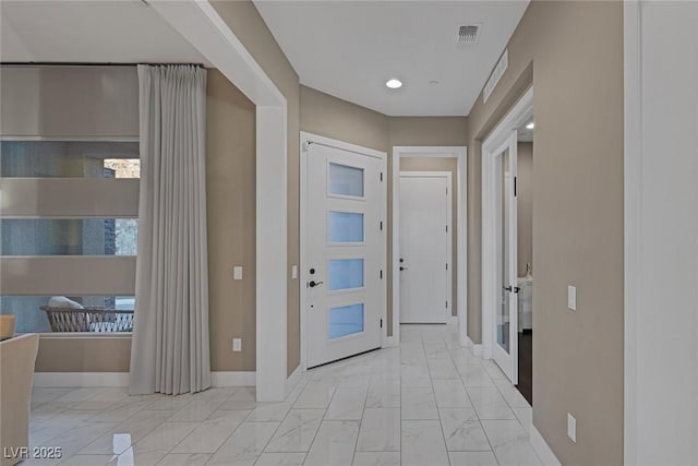 entrance foyer with marble finish floor, visible vents, and baseboards