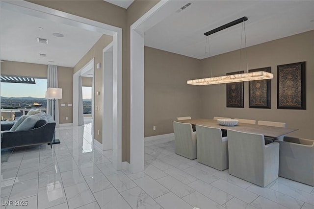 dining room with marble finish floor, visible vents, and baseboards