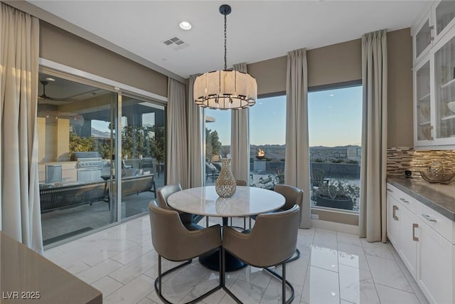 dining area featuring an inviting chandelier, visible vents, marble finish floor, and recessed lighting