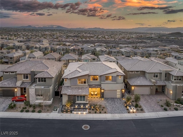 aerial view at dusk featuring a residential view