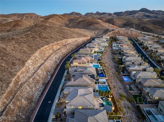 drone / aerial view featuring a residential view and a mountain view