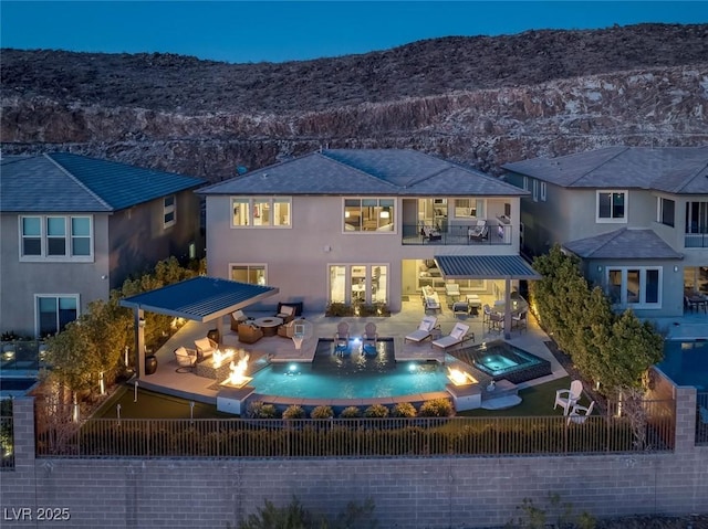 back of property with fence, an outdoor hangout area, exterior kitchen, and stucco siding