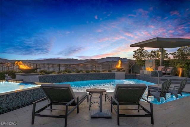 view of pool with a fenced in pool, a patio area, a fenced backyard, and a mountain view