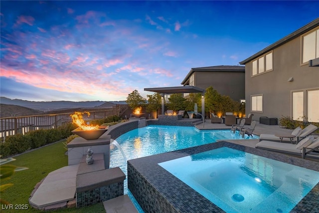 view of swimming pool with an in ground hot tub, a patio area, fence, and a fenced in pool