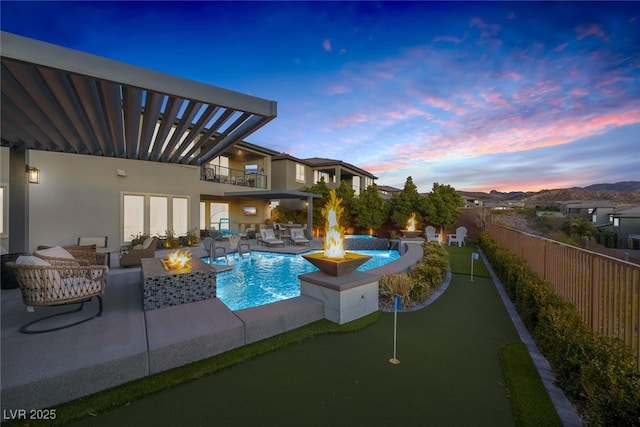 view of pool featuring a patio, an outdoor living space with a fire pit, fence, and a fenced in pool