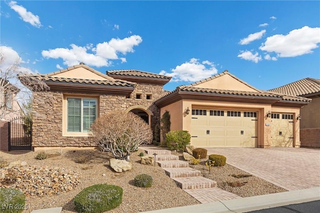 view of front of house with a garage, stone siding, a tiled roof, decorative driveway, and stucco siding