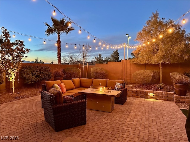 view of patio with a fenced backyard and an outdoor living space with a fire pit