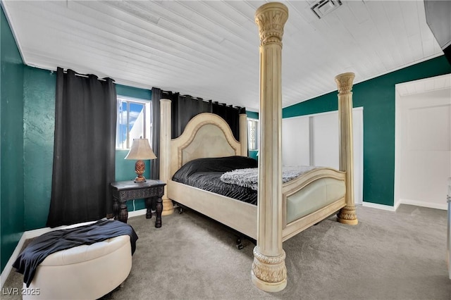 bedroom with baseboards, visible vents, vaulted ceiling, carpet flooring, and ornate columns