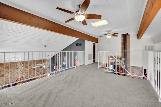 spare room with lofted ceiling with beams, carpet, and visible vents