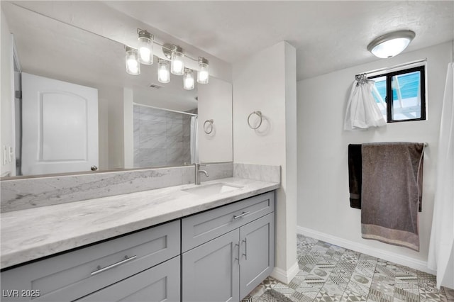 bathroom with curtained shower, vanity, and baseboards