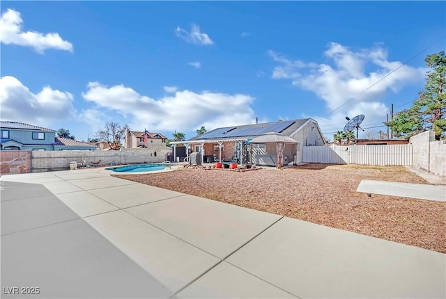 exterior space with a fenced in pool, a patio area, a fenced backyard, and a gazebo