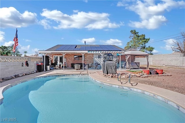 view of swimming pool with a patio area, a fenced backyard, a fenced in pool, and a gazebo