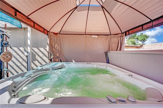 view of patio / terrace with a hot tub