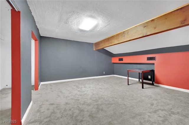 bonus room featuring lofted ceiling with beams, carpet, visible vents, and baseboards