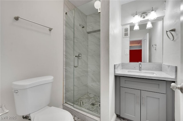 bathroom featuring visible vents, a stall shower, vanity, and toilet