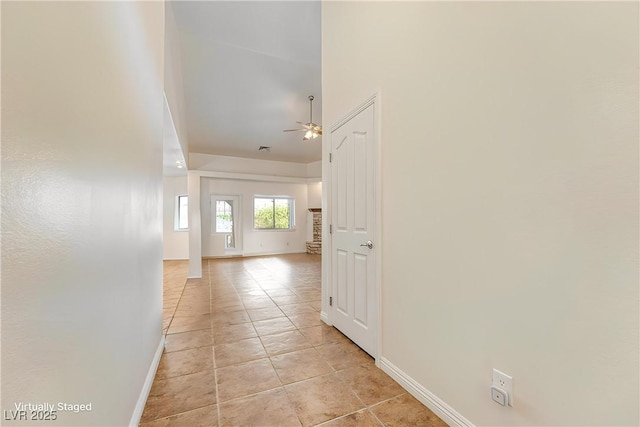 hall featuring light tile patterned flooring