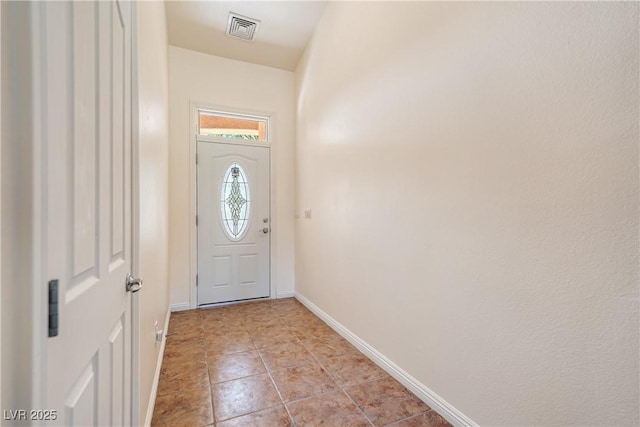 entryway with light tile patterned flooring