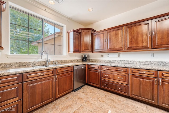 kitchen featuring light tile patterned flooring, dishwasher, sink, and light stone countertops