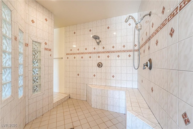 bathroom with tiled shower and tile walls