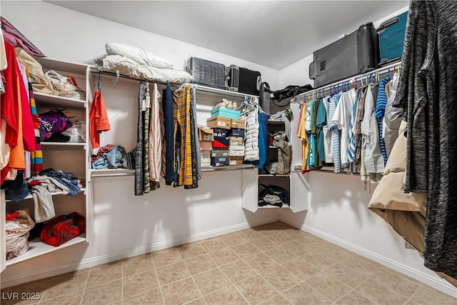 spacious closet with tile patterned floors