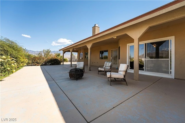 view of patio with a fire pit