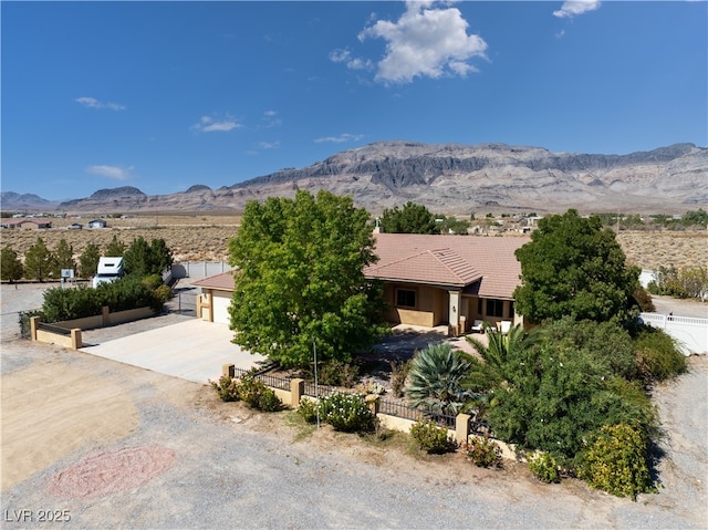 view of front of property with a garage and a mountain view