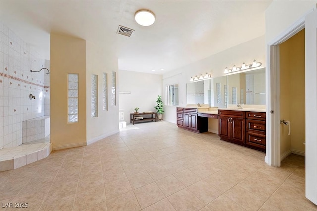 bathroom with vanity, tile patterned flooring, and a shower