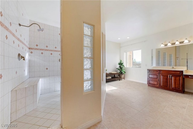 bathroom featuring walk in shower, tile patterned floors, and vanity