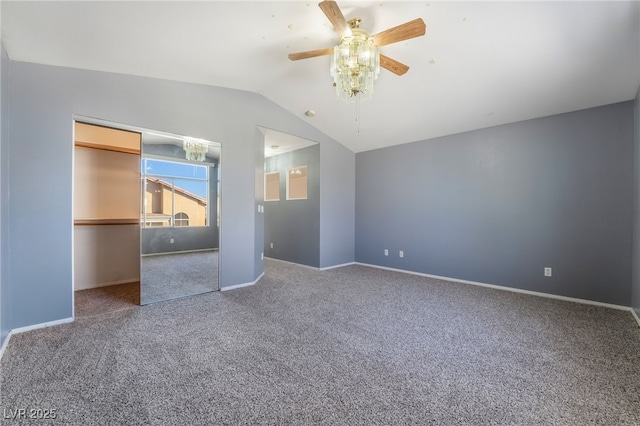 unfurnished bedroom with lofted ceiling, a closet, ceiling fan, and carpet flooring