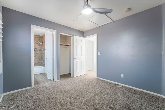 unfurnished bedroom with ensuite bathroom, light colored carpet, ceiling fan, and a closet