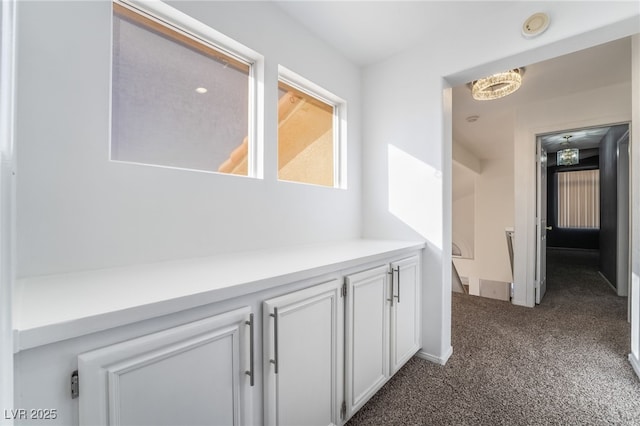 hallway with dark carpet