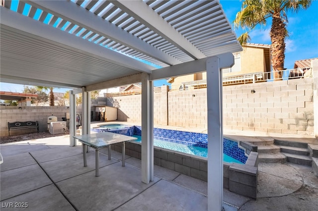 view of patio / terrace with an in ground hot tub