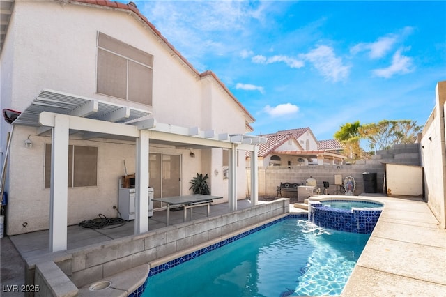 view of pool with an in ground hot tub, a patio area, and a pergola