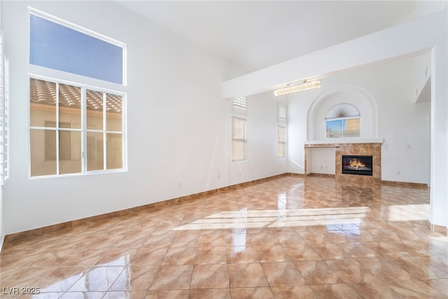 unfurnished living room featuring a tile fireplace