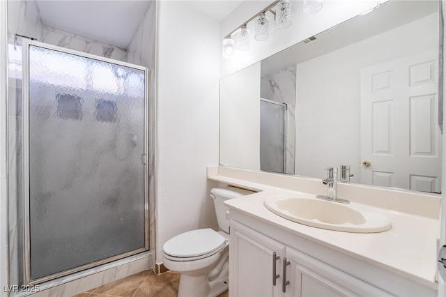 bathroom with vanity, a shower with shower door, tile patterned floors, and toilet