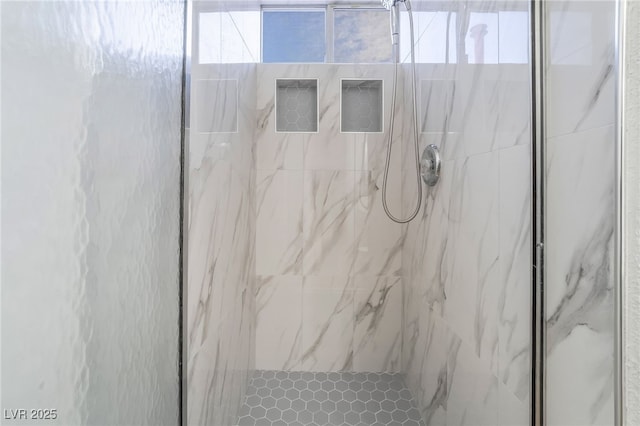 bathroom with a tile shower